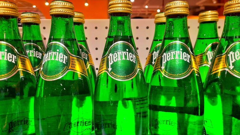 Rows of Perrier water on supermarket shelf