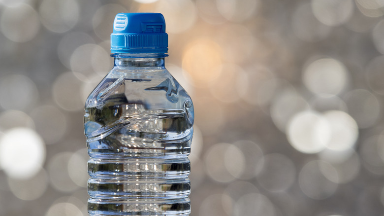 Single plastic bottle of drinking water with blue cap