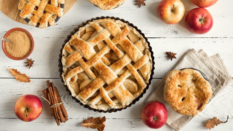 homemade apple pies on wood