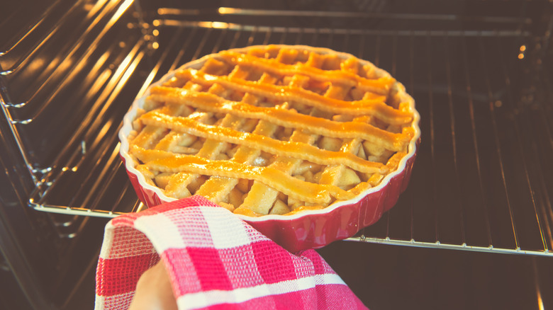 apple pie placed into oven