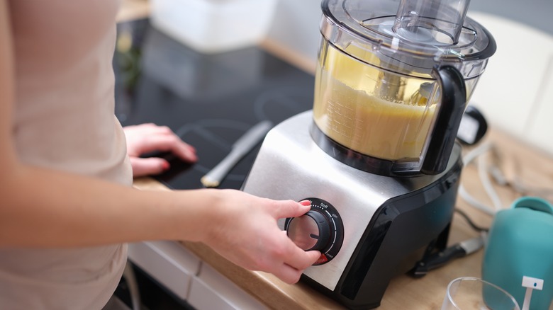 Woman blending pie filling in a food processor