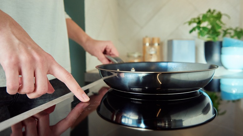 Person using cooktop