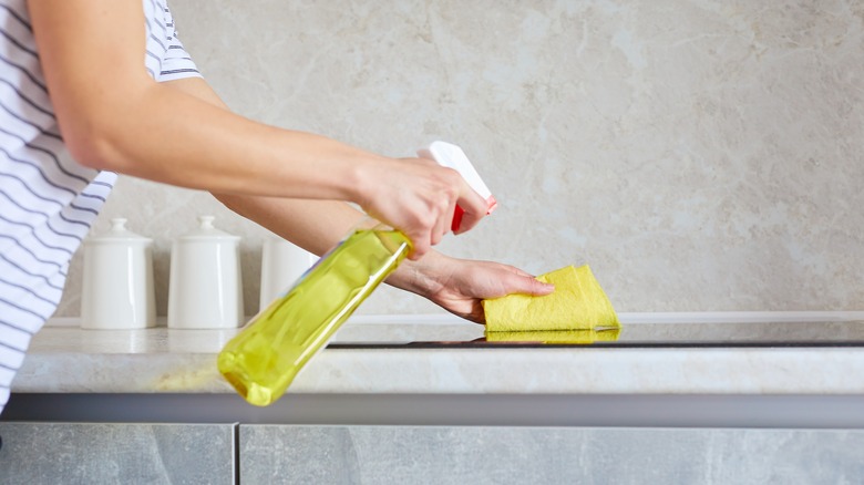 Person cleaning cooktop