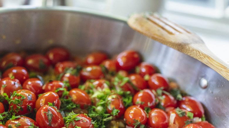 Tomatoes cooking in stainless steel 