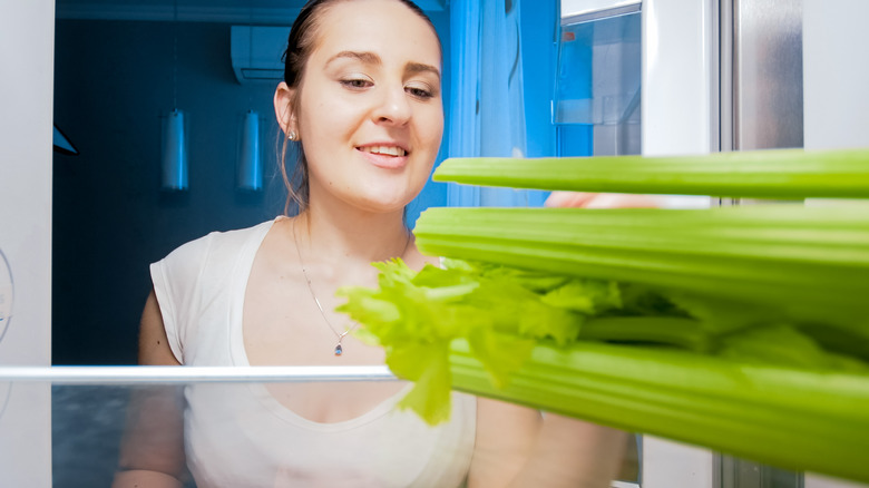 woman looking at celery