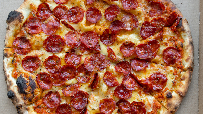 Sliced pepperoni pizza in cardboard box