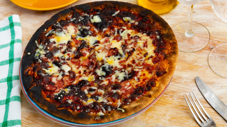 Burnt pizza on restaurant table