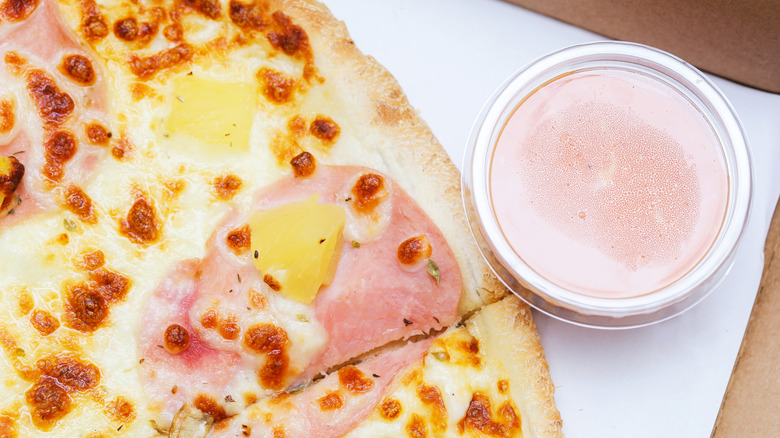 Pizza in cardboard box with dip