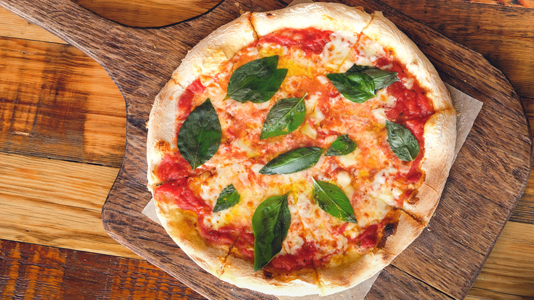 Pizza Margherita with fresh basil on top