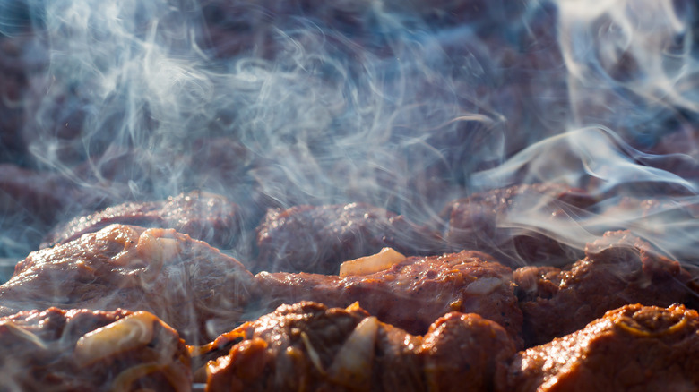 barbecue on grill with smoke