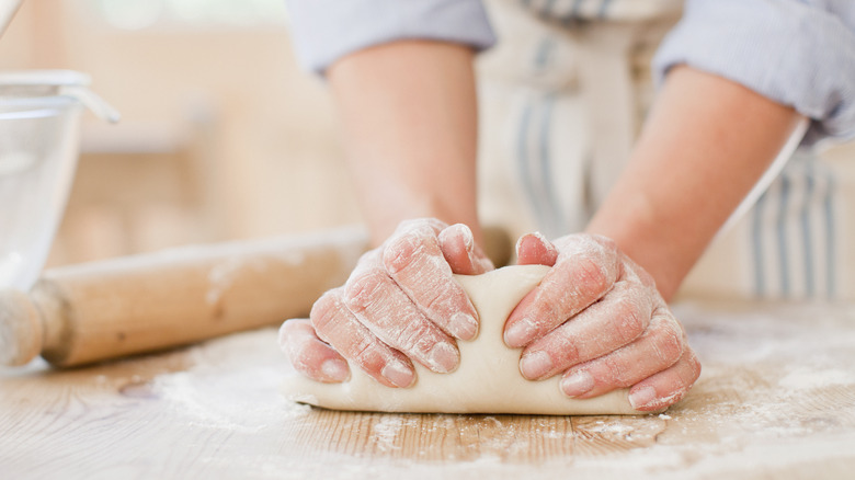 woman kneading dough