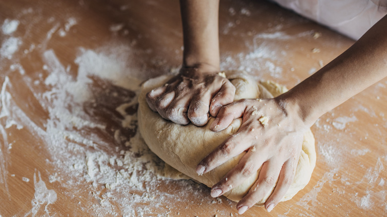 Person kneading bread dough