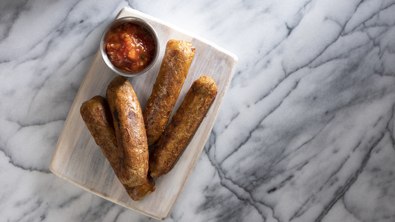 cooked plant-based sausages with sauce