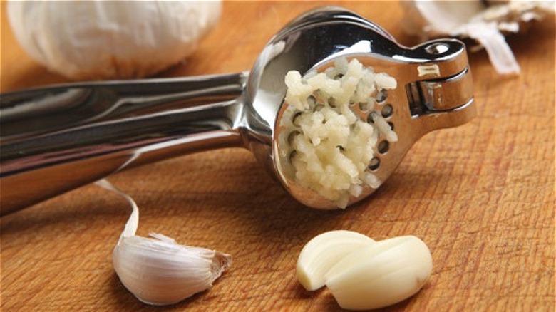 garlic press with fresh garlic