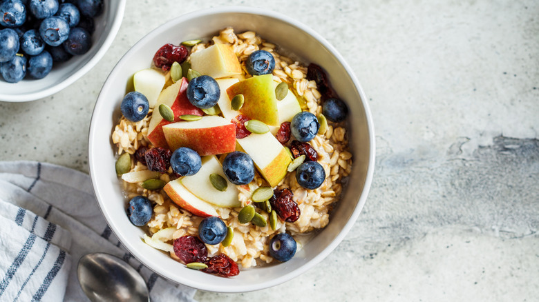 Fresh fruits and seeds over oats