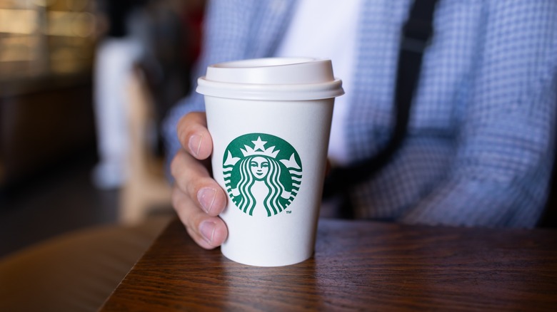 Person holding Starbucks cup