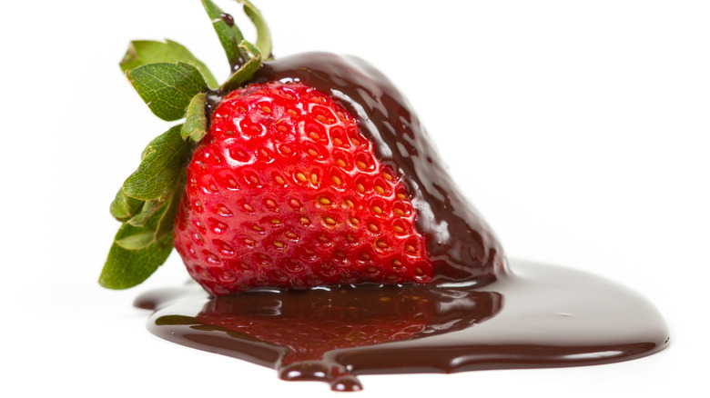 Strawberry with pool of chocolate