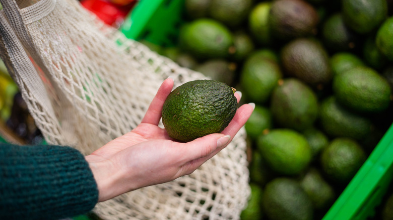 person buying avocados