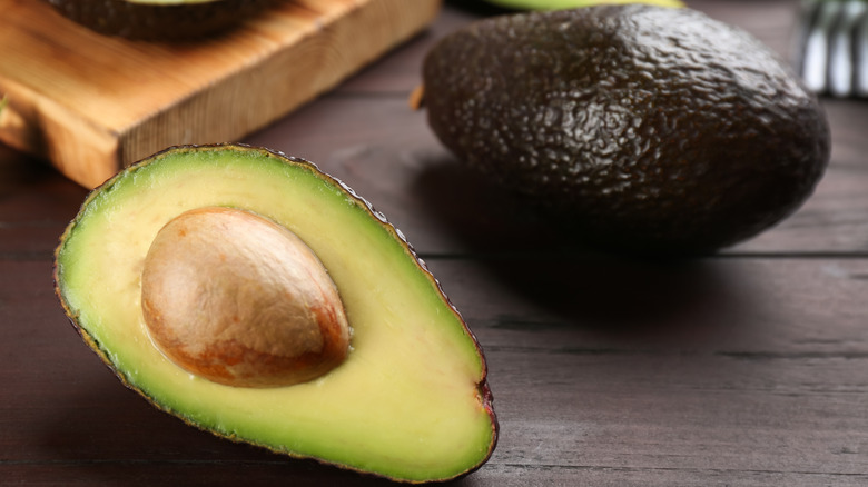 cut and whole avocado