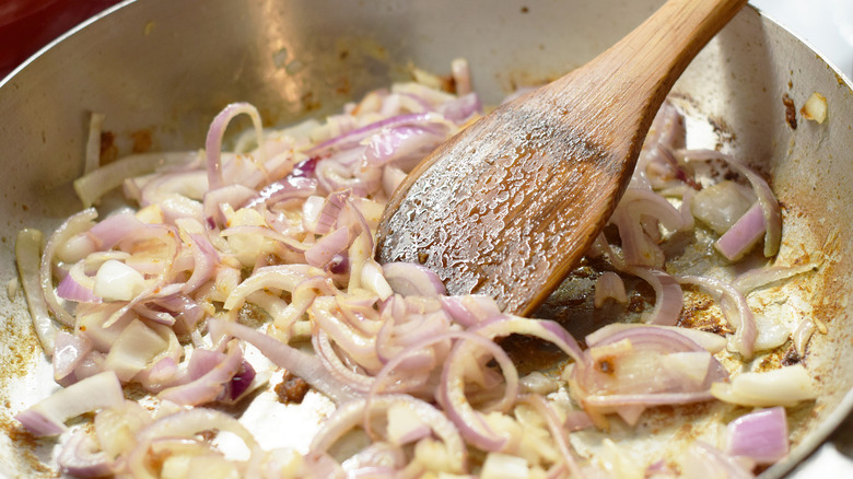 onions being fried in pan