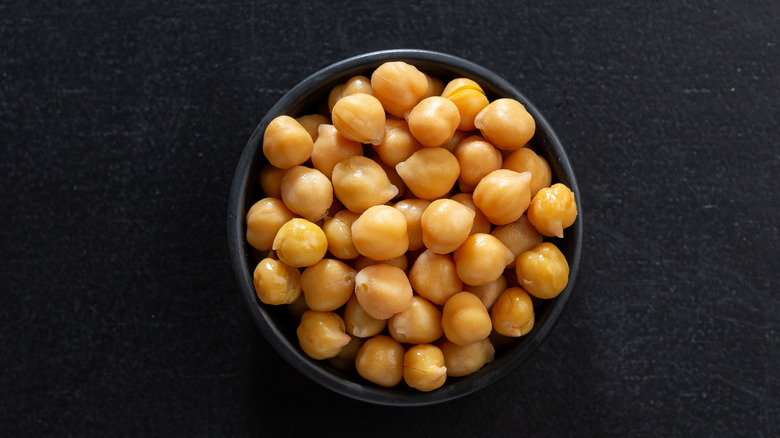 chickpeas in bowl on dark background