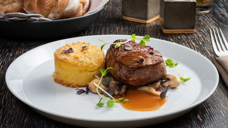 Steak with potato pave, mushrooms, and garnish