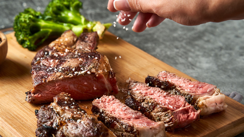 Steak being sprinkled onto steak