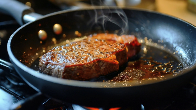 Steak searing in frying pan