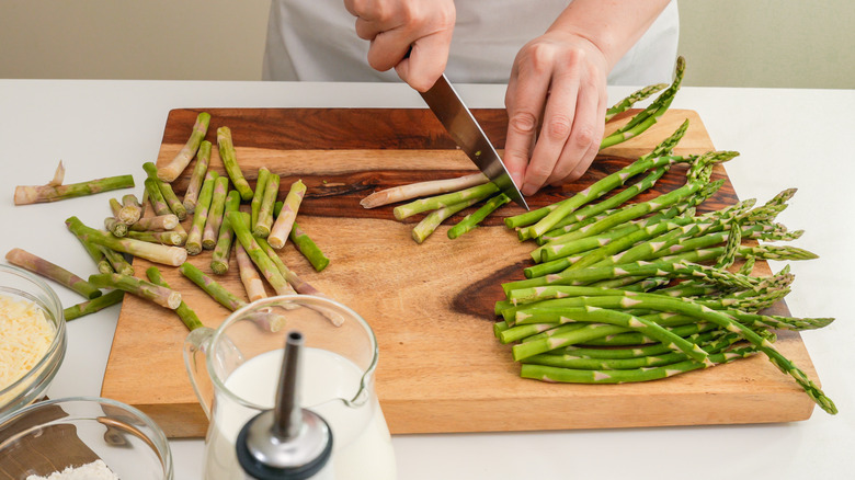 person cutting asparagus stalks