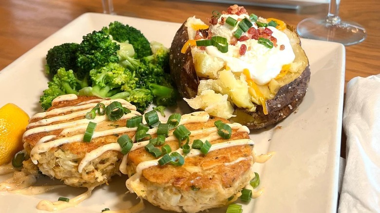 Two crab cakes and loaded potato