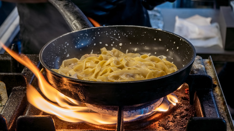 Pasta noodles cooking in pan