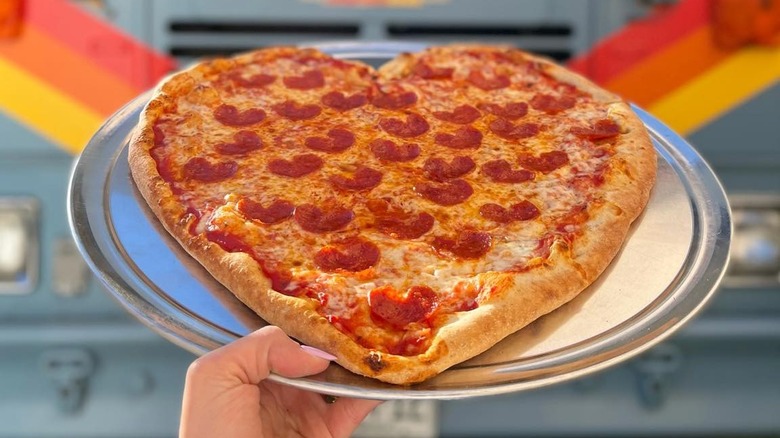 Heart shaped pizza on platter