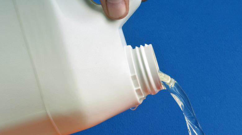 bleach being poured from bottle