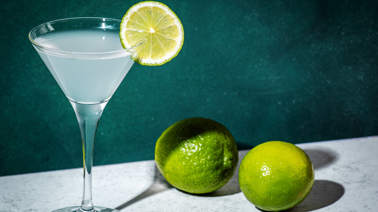 Gimlet cocktail and limes