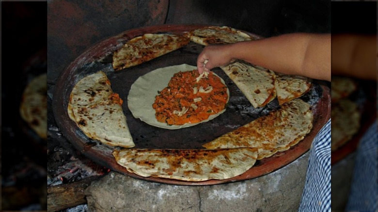 empanadas de amarillo being cooked on griddle