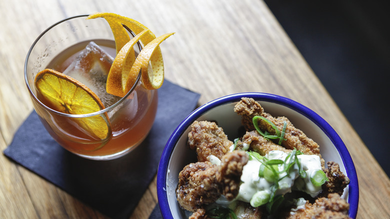 Cocktail and bowl of chicken