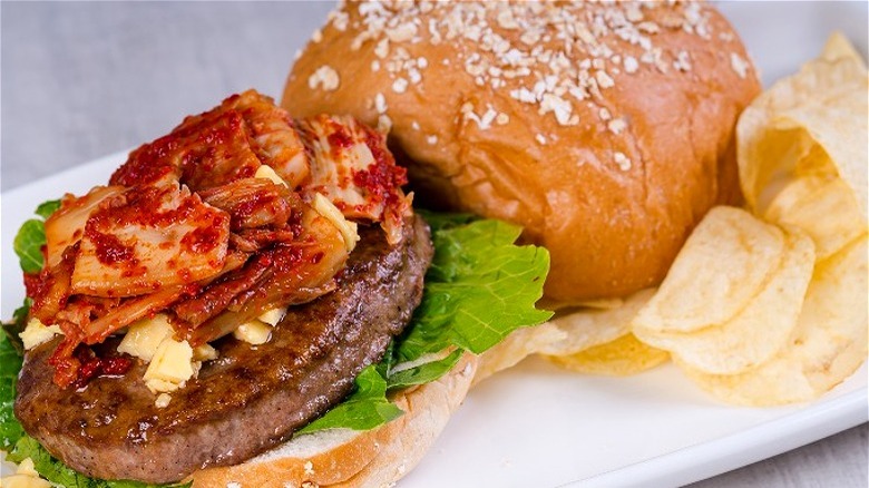 open kimchi burger with chips 