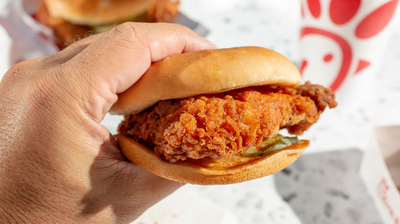 hand holding chick-fil-a sandwich