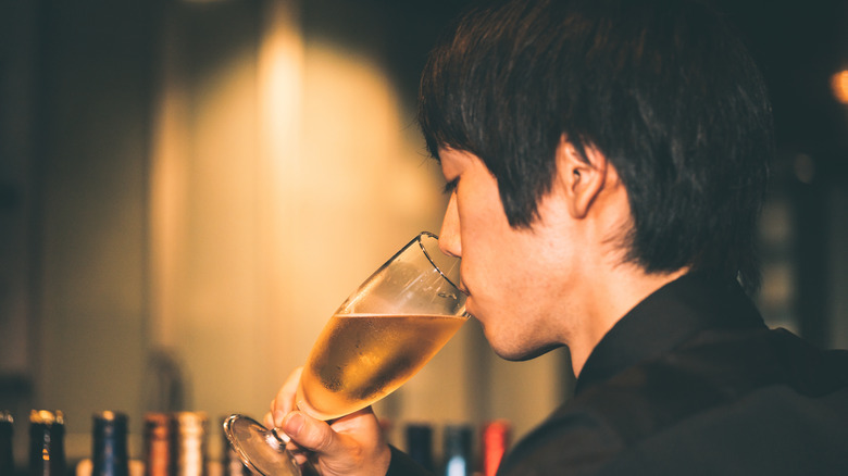 Man drinking glass of beer