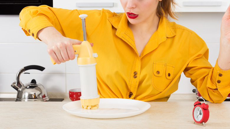 woman using cookie press