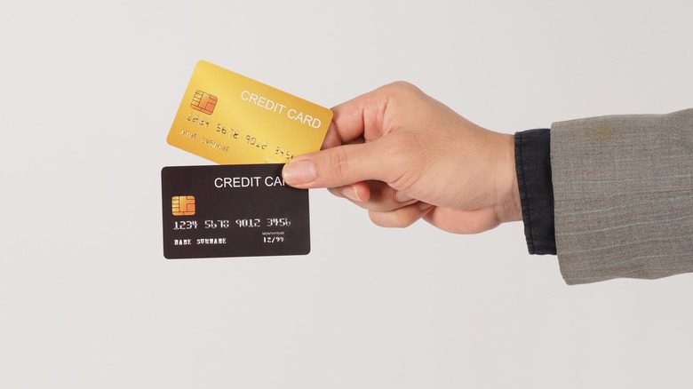 Hand holding two credit cards