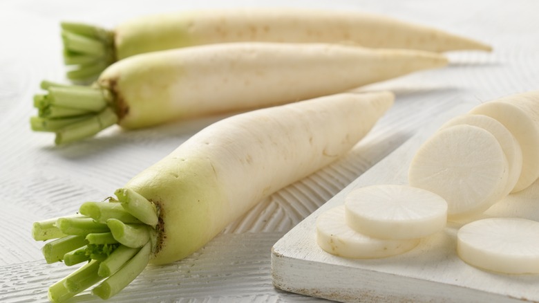 Daikon radishes on cutting board