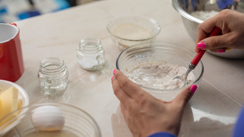 Hand mixing yeast in bowl table