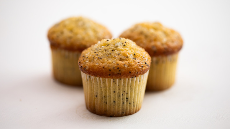 Three lemon and poppyseed muffins