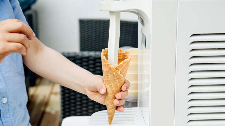 Kid using soft serve machine