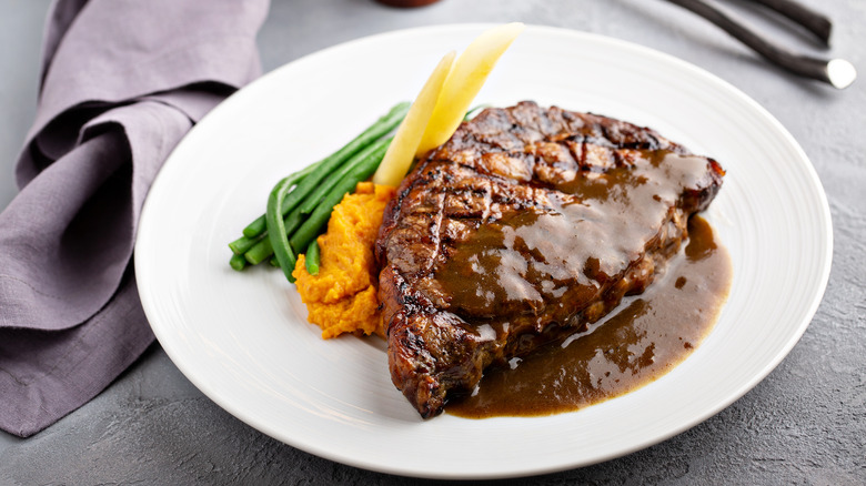 Steak with brown gravy and vegetables