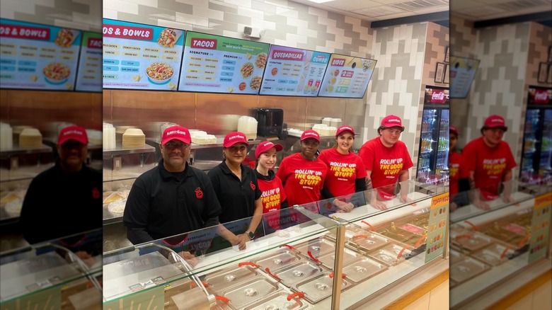 Burritobar employees standing behind the counter in a Burritobar restaurant