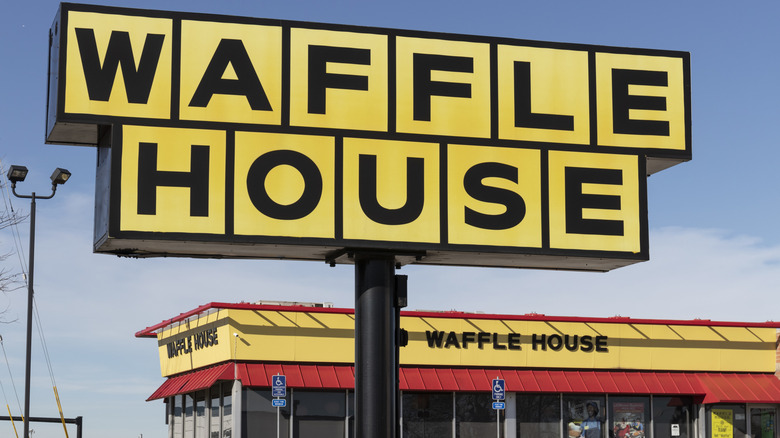 A Waffle House sign in front of the restaurant