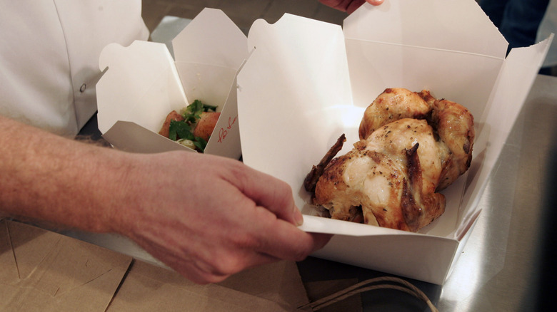 chef packing up rotisserie chicken