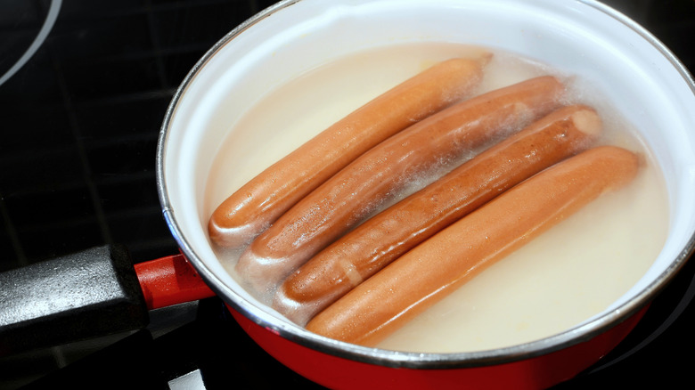 sausages boiling in a pan